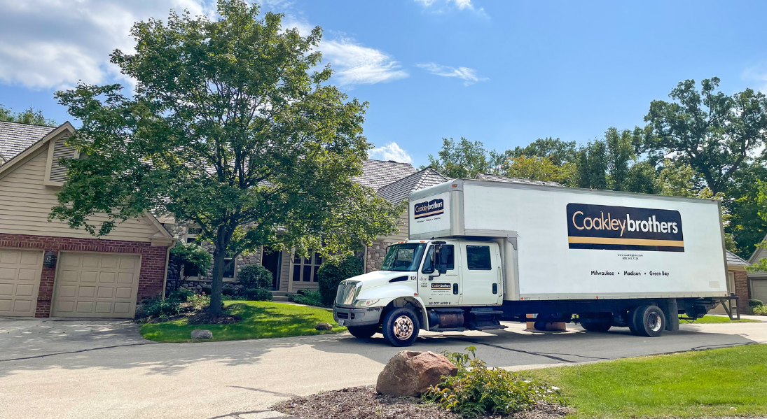Coakley Brothers Moving Truck Outside of A Residential Home